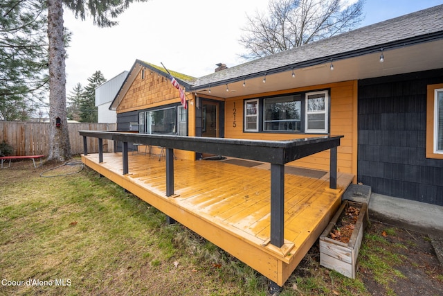 deck featuring fence and a lawn