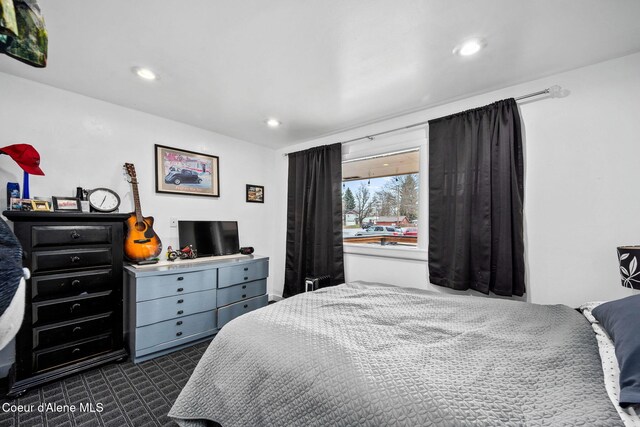 bedroom with recessed lighting and dark carpet