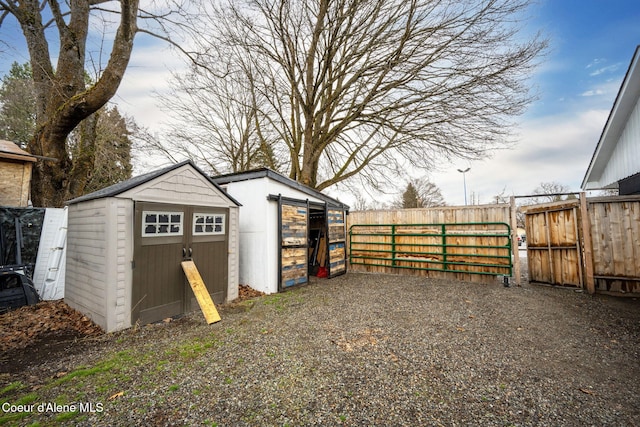 view of shed featuring fence