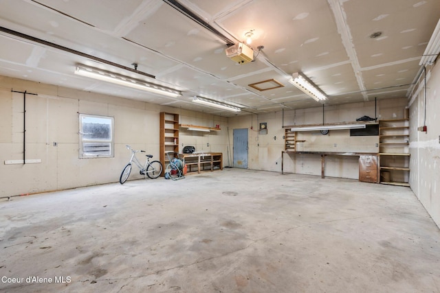 garage with a workshop area and a garage door opener