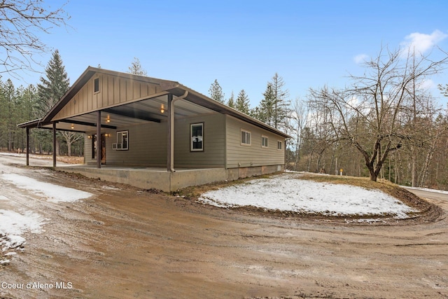 view of side of property featuring a carport and a patio area