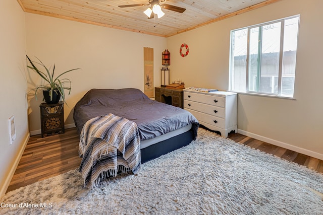bedroom featuring crown molding, wood finished floors, baseboards, and wooden ceiling