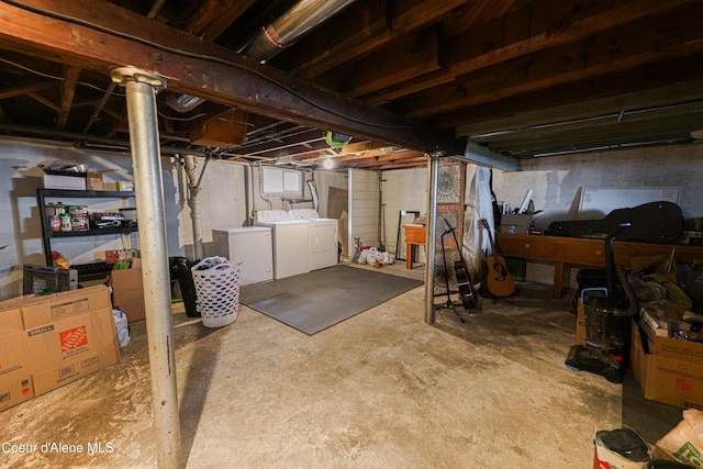 unfinished below grade area featuring independent washer and dryer