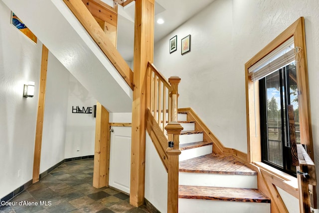 staircase with stone finish flooring and baseboards