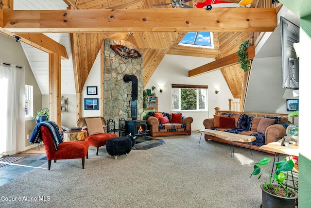 carpeted living room featuring beam ceiling, a wood stove, and high vaulted ceiling