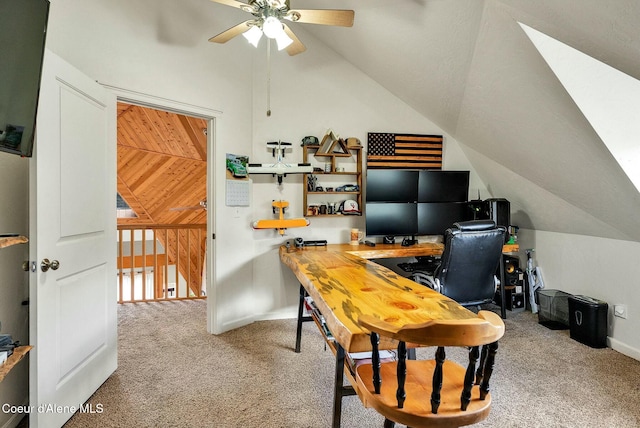 carpeted office featuring lofted ceiling and a ceiling fan