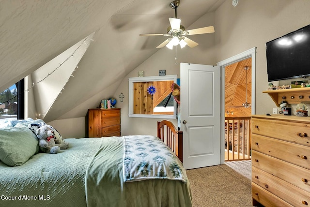 carpeted bedroom with ceiling fan and vaulted ceiling