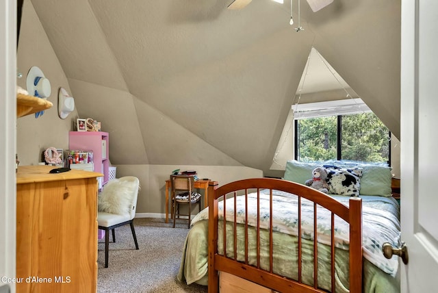 carpeted bedroom with vaulted ceiling and baseboards