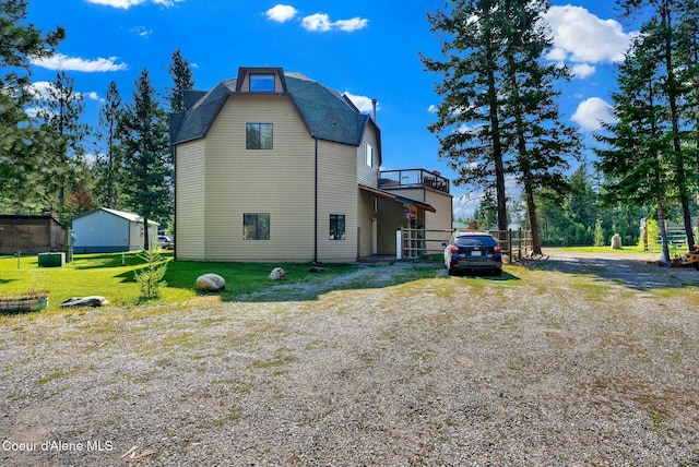 view of side of property with a lawn and driveway