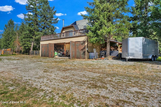 back of property featuring an outbuilding, a garage, and a pole building