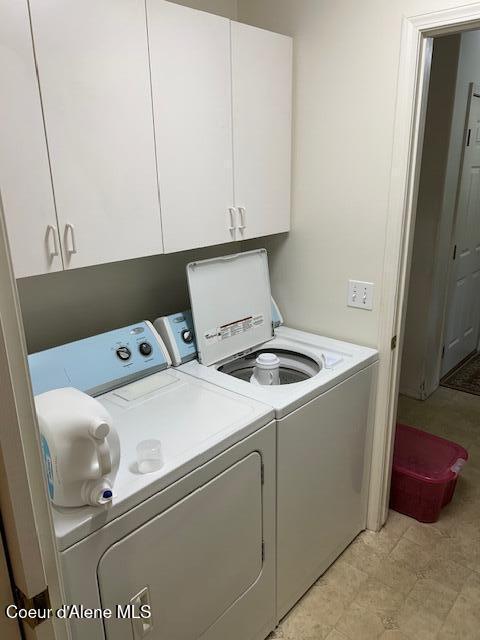 laundry area featuring washer and dryer and cabinet space