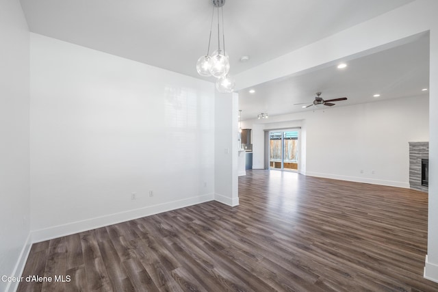 1006 E Garden Ave, Coeur Dalene, ID 83814 - interior space with baseboards, a tile fireplace, dark wood-style floors, and ceiling fan