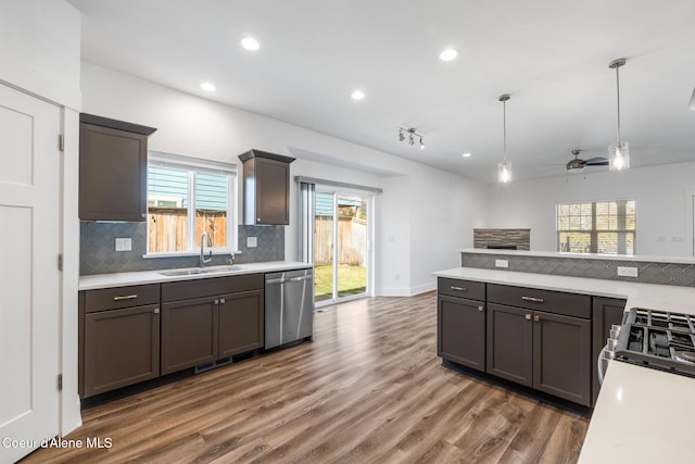 1006 E Garden Ave, Coeur Dalene, ID 83814 - kitchen with stainless steel dishwasher, light countertops, a sink, and backsplash