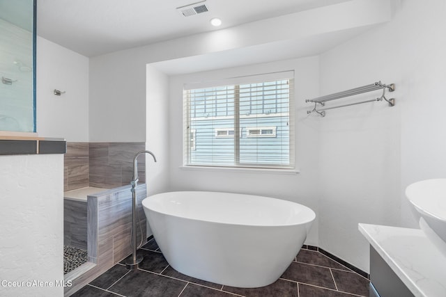 1006 E Garden Ave, Coeur Dalene, ID 83814 - bathroom with a tile shower, tile patterned floors, visible vents, vanity, and a soaking tub