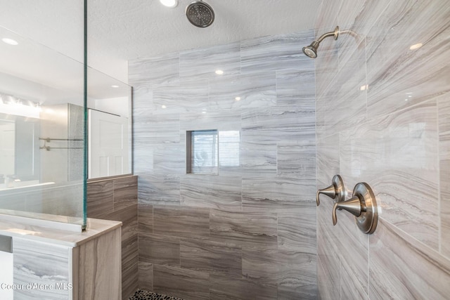 1006 E Garden Ave, Coeur Dalene, ID 83814 - full bathroom with walk in shower, a textured ceiling, and tile walls