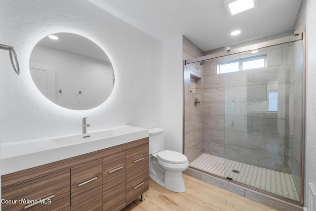 1006 E Garden Ave, Coeur Dalene, ID 83814 - bathroom featuring recessed lighting, wood finished floors, toilet, vanity, and a stall shower