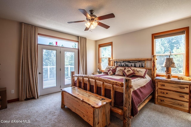 bedroom with light carpet, a textured ceiling, a ceiling fan, and access to outside