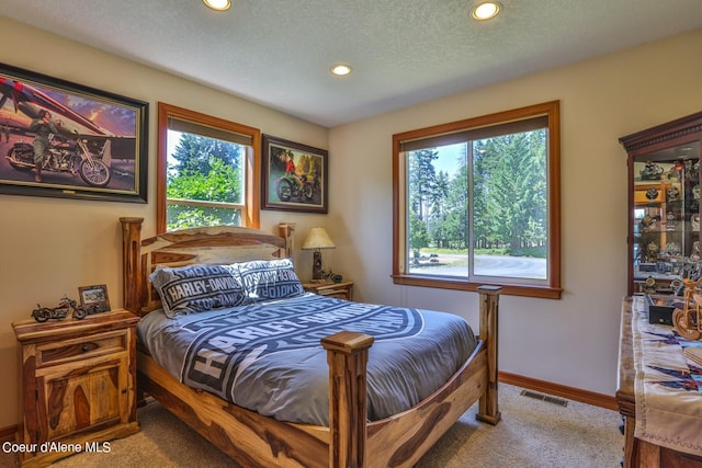 carpeted bedroom with recessed lighting, baseboards, visible vents, and a textured ceiling