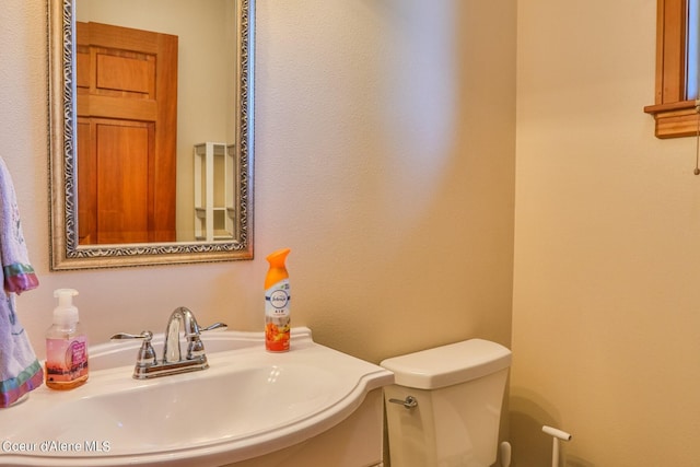 bathroom featuring a sink and toilet