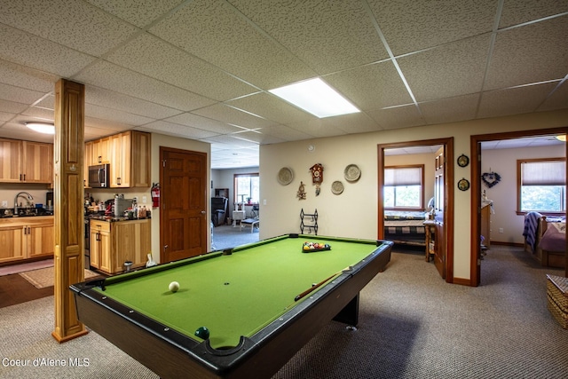 rec room featuring pool table, a paneled ceiling, a healthy amount of sunlight, and a sink