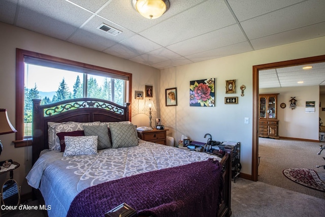 bedroom with visible vents, a paneled ceiling, baseboards, and carpet floors