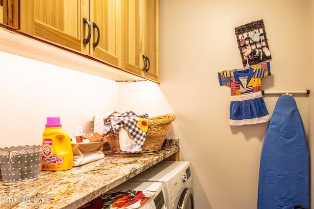 laundry area with washer and dryer and cabinet space