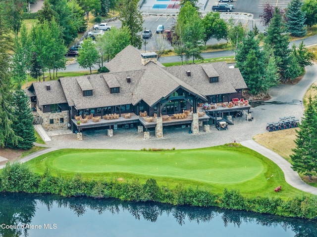 birds eye view of property featuring golf course view and a water view