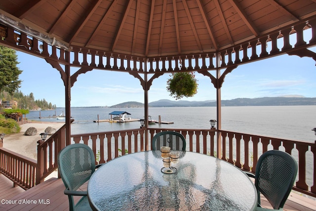 190 W Eagle Crest Dr, Coeur Dalene, ID 83814 - wooden deck with a gazebo, outdoor dining space, a dock, and a water and mountain view