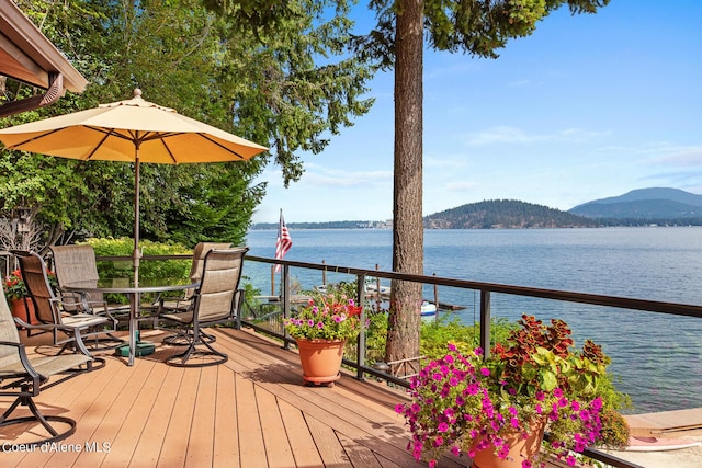 190 W Eagle Crest Dr, Coeur Dalene, ID 83814 - wooden terrace with outdoor dining area and a water and mountain view