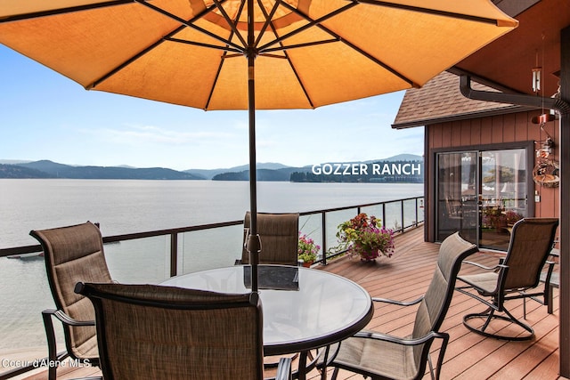 190 W Eagle Crest Dr, Coeur Dalene, ID 83814 - wooden terrace featuring outdoor dining area and a water and mountain view