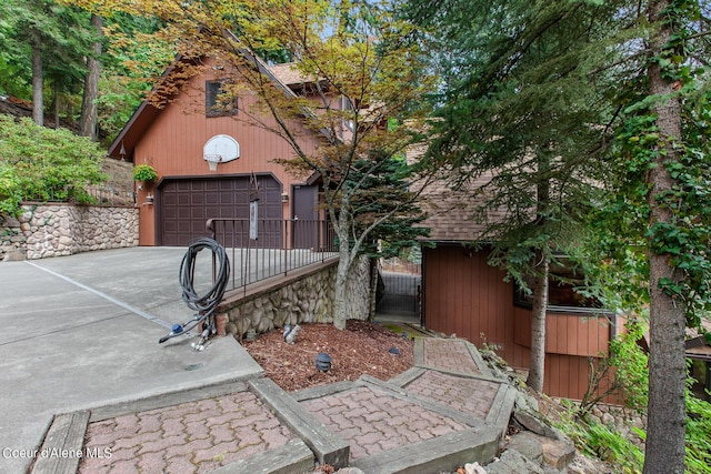 190 W Eagle Crest Dr, Coeur Dalene, ID 83814 - view of patio / terrace with an outdoor structure, concrete driveway, and fence