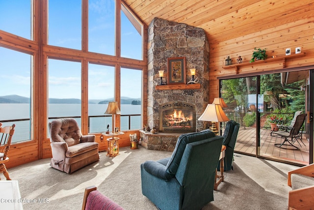 190 W Eagle Crest Dr, Coeur Dalene, ID 83814 - carpeted living area featuring high vaulted ceiling, wooden walls, a fireplace, a water and mountain view, and wood ceiling