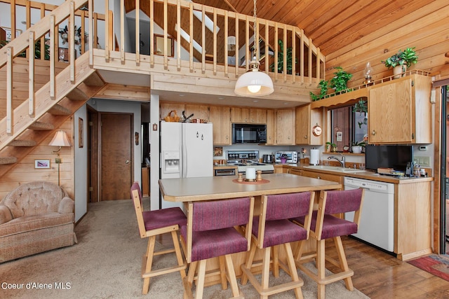 190 W Eagle Crest Dr, Coeur Dalene, ID 83814 - kitchen featuring wooden walls, wood ceiling, light countertops, white appliances, and a sink