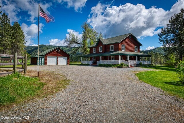 415 Shale Rd, Priest River, ID 83856 - view of front of property with a porch, an outbuilding, driveway, and a detached garage