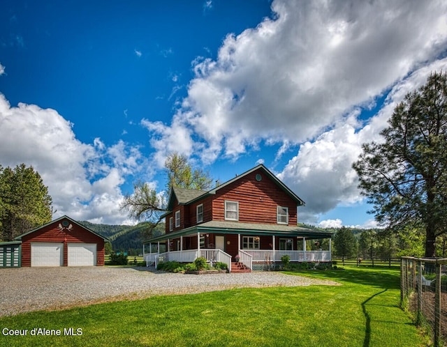 415 Shale Rd, Priest River, ID 83856 - view of front of house featuring covered porch, an outdoor structure, and a garage