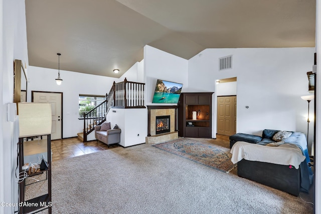 7068 N Epervier Ln, Coeur Dalene, ID 83815 - carpeted living room with high vaulted ceiling, stairway, and a fireplace