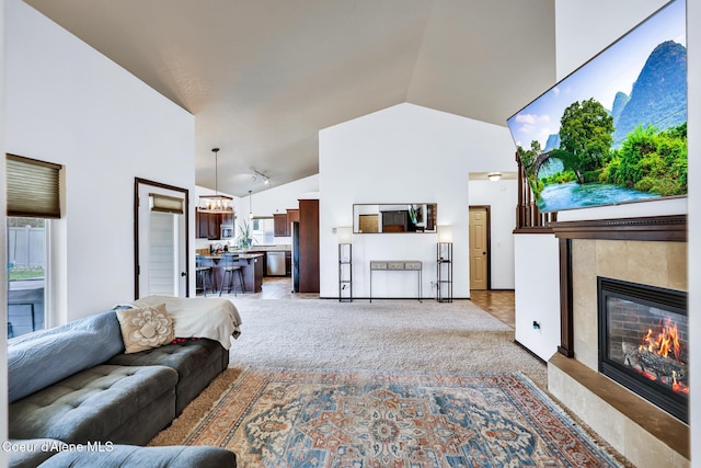 7068 N Epervier Ln, Coeur Dalene, ID 83815 - living area featuring a fireplace, light colored carpet, and high vaulted ceiling