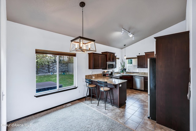 7068 N Epervier Ln, Coeur Dalene, ID 83815 - kitchen featuring lofted ceiling, appliances with stainless steel finishes, a peninsula, dark brown cabinetry, and track lighting