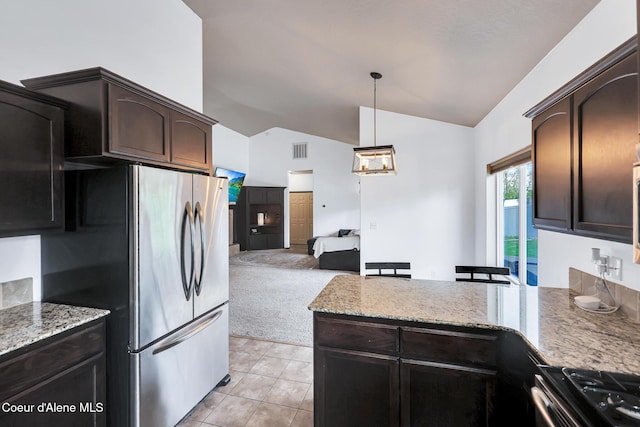 7068 N Epervier Ln, Coeur Dalene, ID 83815 - kitchen featuring lofted ceiling, freestanding refrigerator, stove, a peninsula, and dark brown cabinets