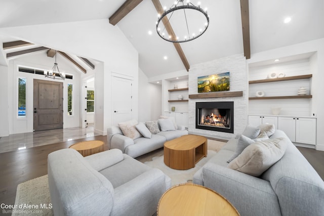 living room with a fireplace, beam ceiling, a chandelier, and wood finished floors
