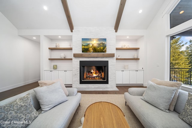 living area with built in shelves, a fireplace, lofted ceiling with beams, baseboards, and dark wood-type flooring