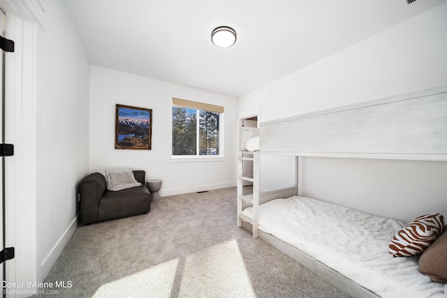 bedroom featuring baseboards and carpet floors