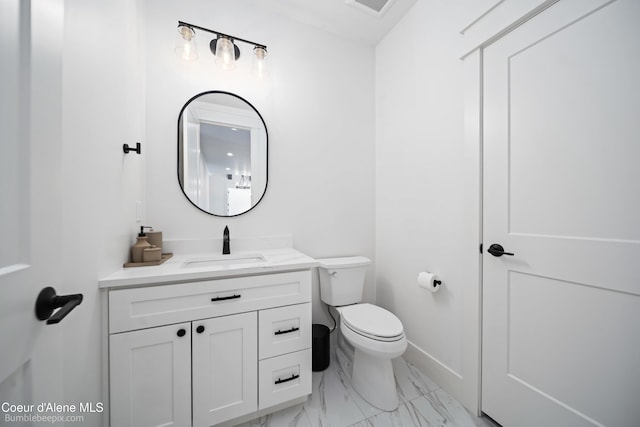 bathroom with baseboards, marble finish floor, toilet, and vanity
