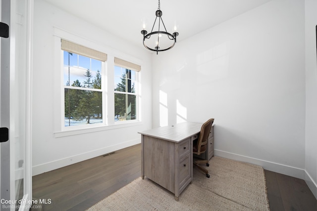 office featuring baseboards, visible vents, wood finished floors, and an inviting chandelier