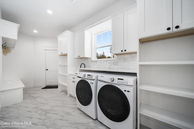 laundry area featuring recessed lighting, baseboards, marble finish floor, cabinet space, and washing machine and dryer