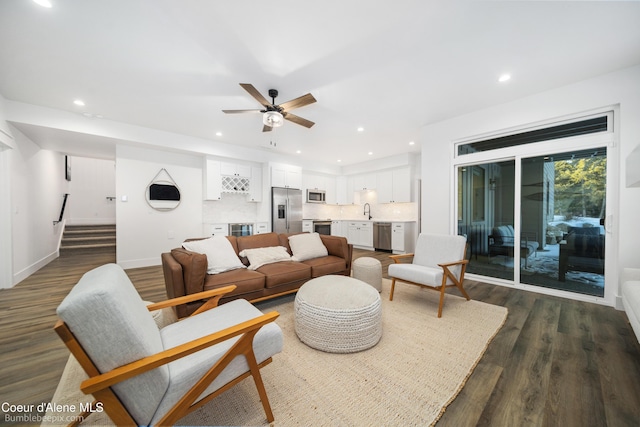 living room with a ceiling fan, dark wood finished floors, stairway, and recessed lighting