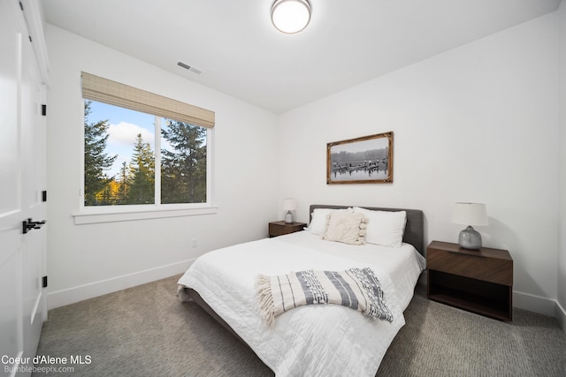 carpeted bedroom featuring baseboards and visible vents