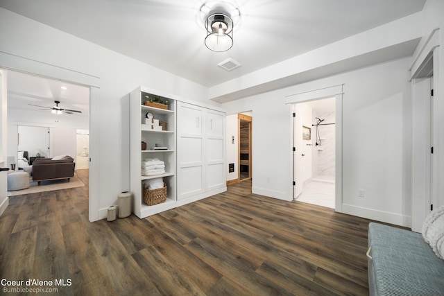 bedroom featuring a closet, visible vents, baseboards, connected bathroom, and dark wood-style floors