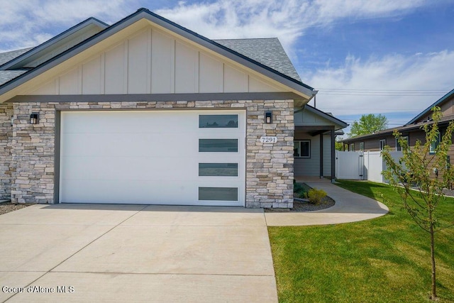 7365 N Breaux, Coeur Dalene, ID 83815 - view of front of property featuring board and batten siding, stone siding, a shingled roof, and driveway