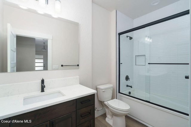 7365 N Breaux, Coeur Dalene, ID 83815 - full bath with toilet, wood finished floors, vanity, and bath / shower combo with glass door